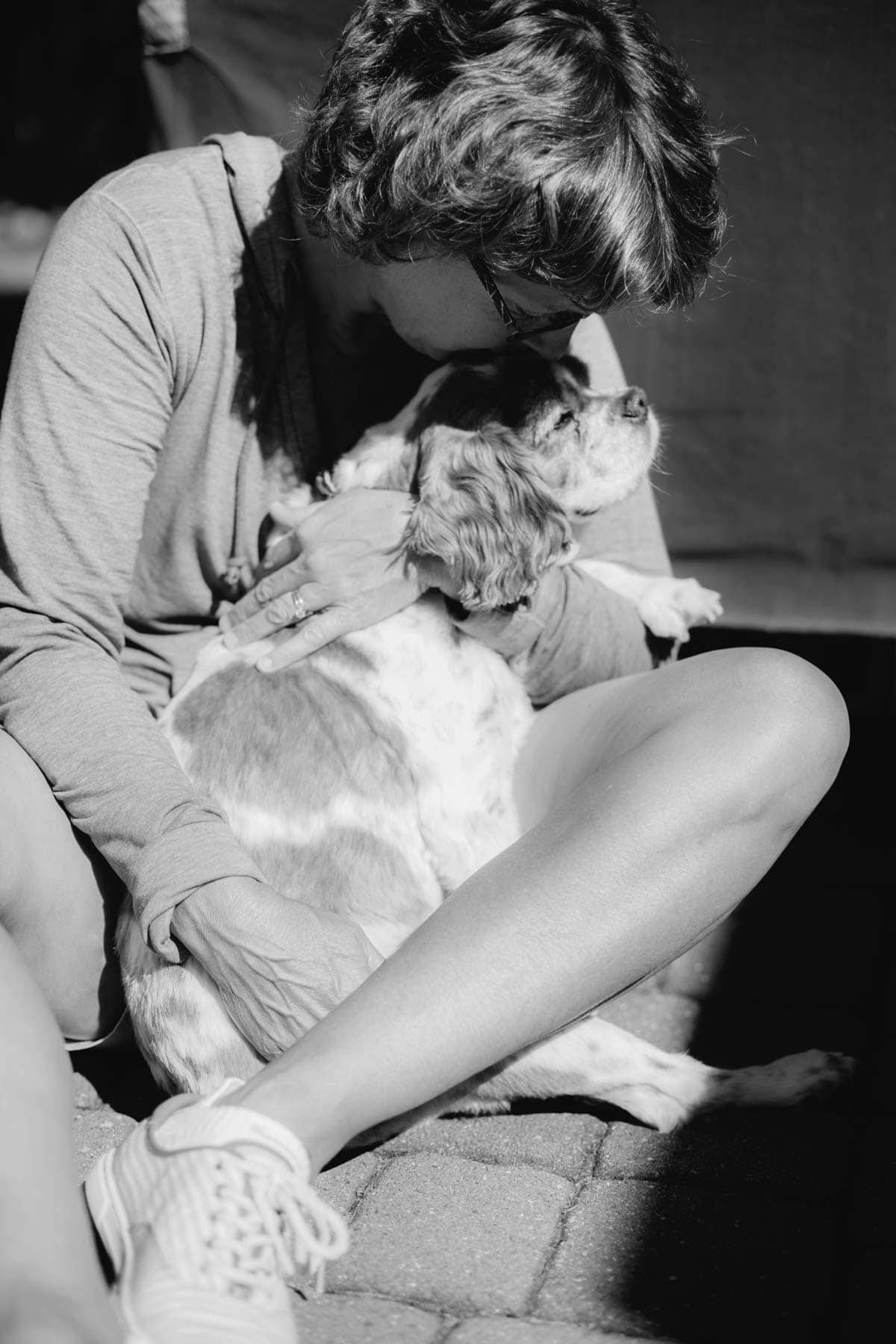 Woman kissing a dog.